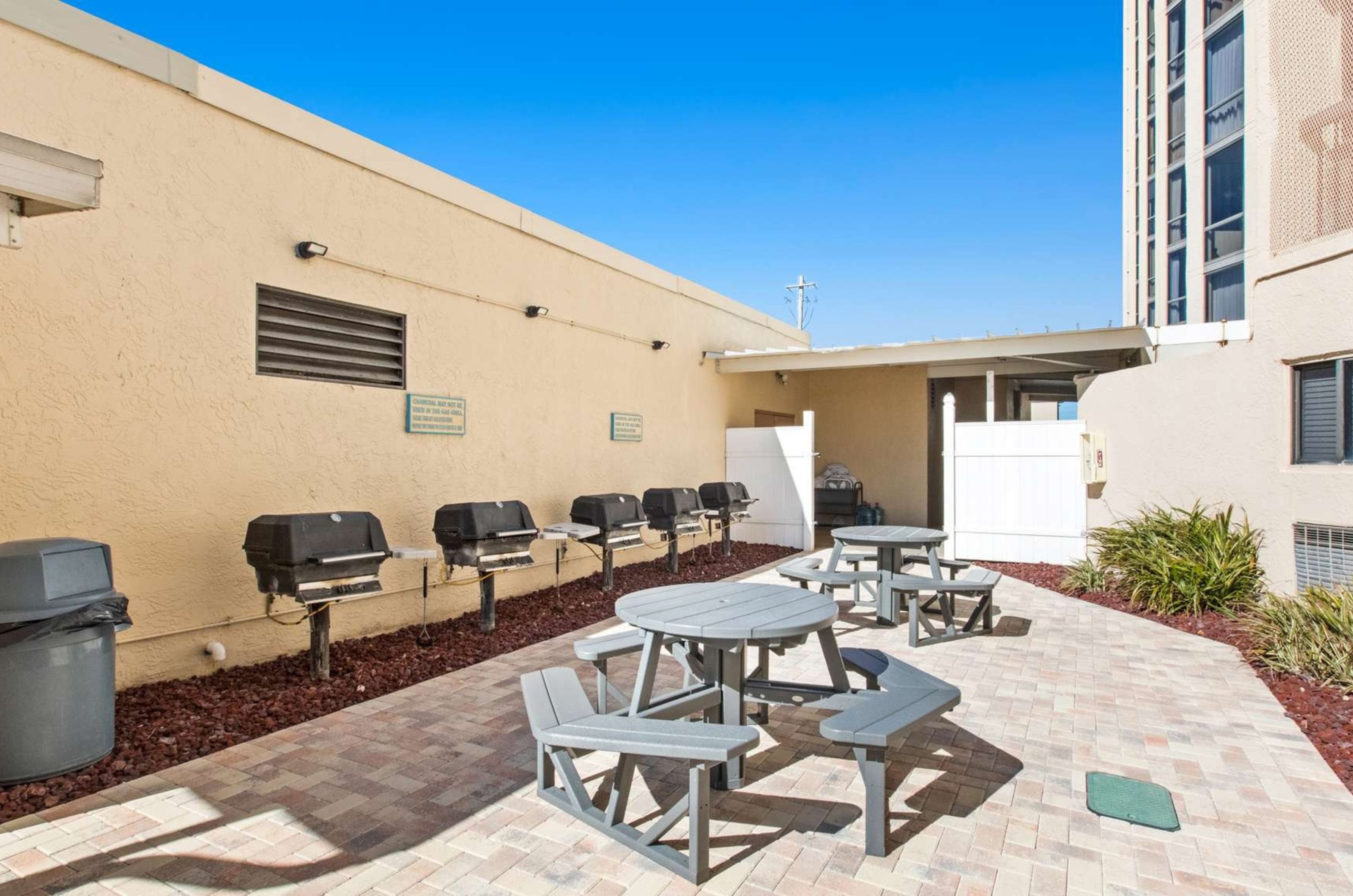 The outdoor barbecue grills next to picnic tables at SunDestin Beach Resort in Destin Florida 