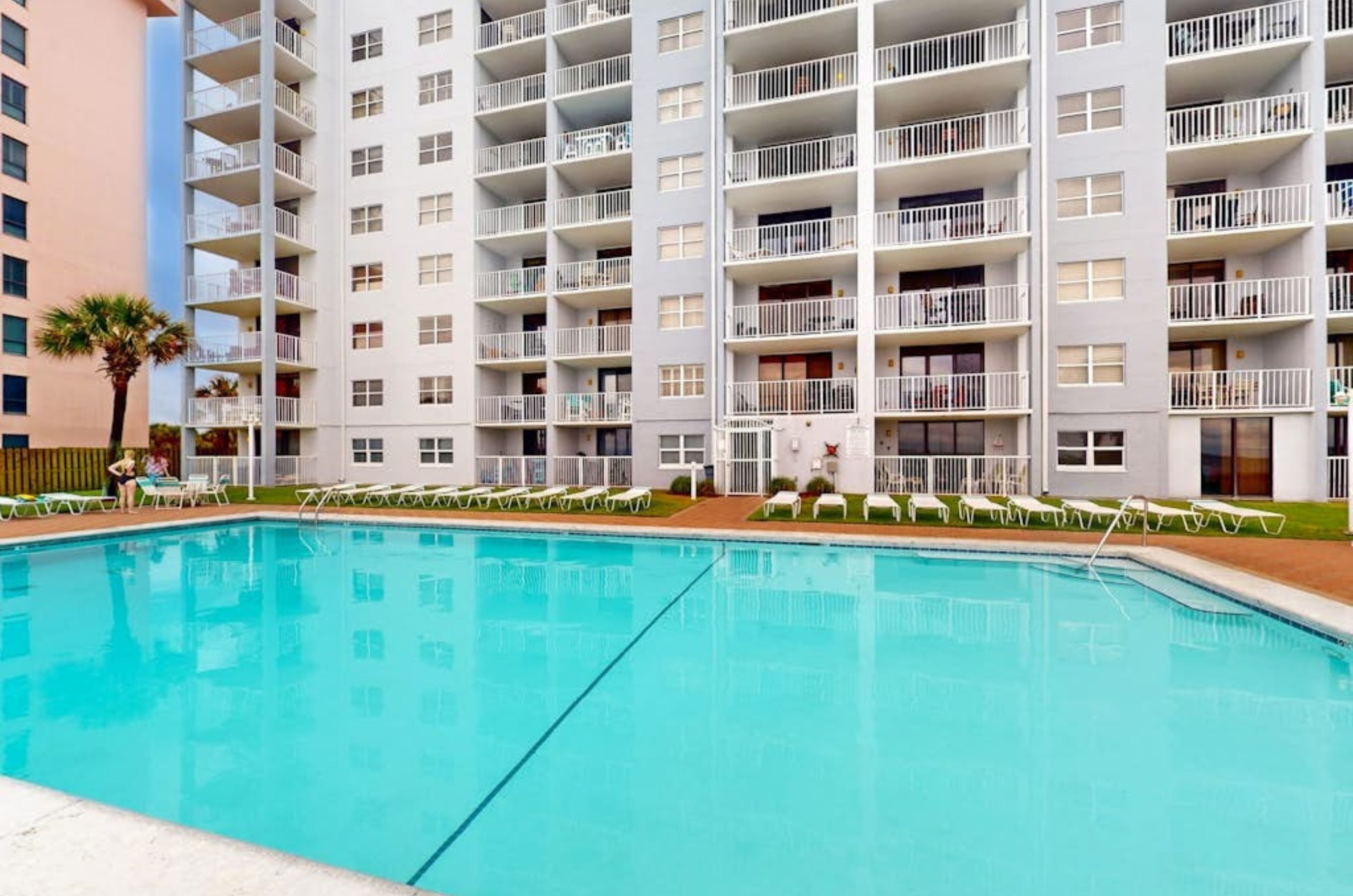 The outdoor swimming pool in front of Sunswept Condominiums	