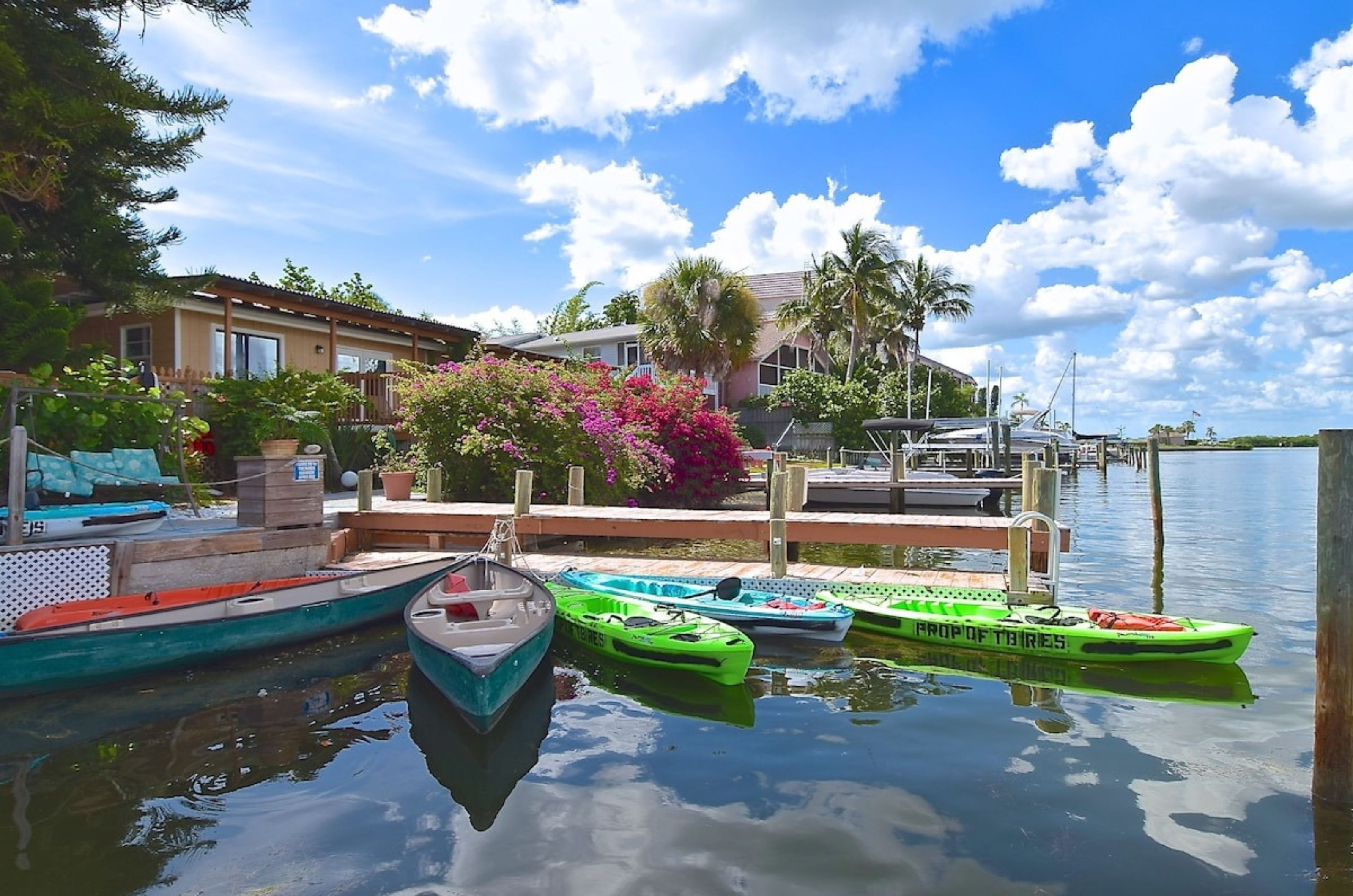 The wooden deck on the water with kayaks at the Inn at Turtle Beach in Siesta Key Florida	
