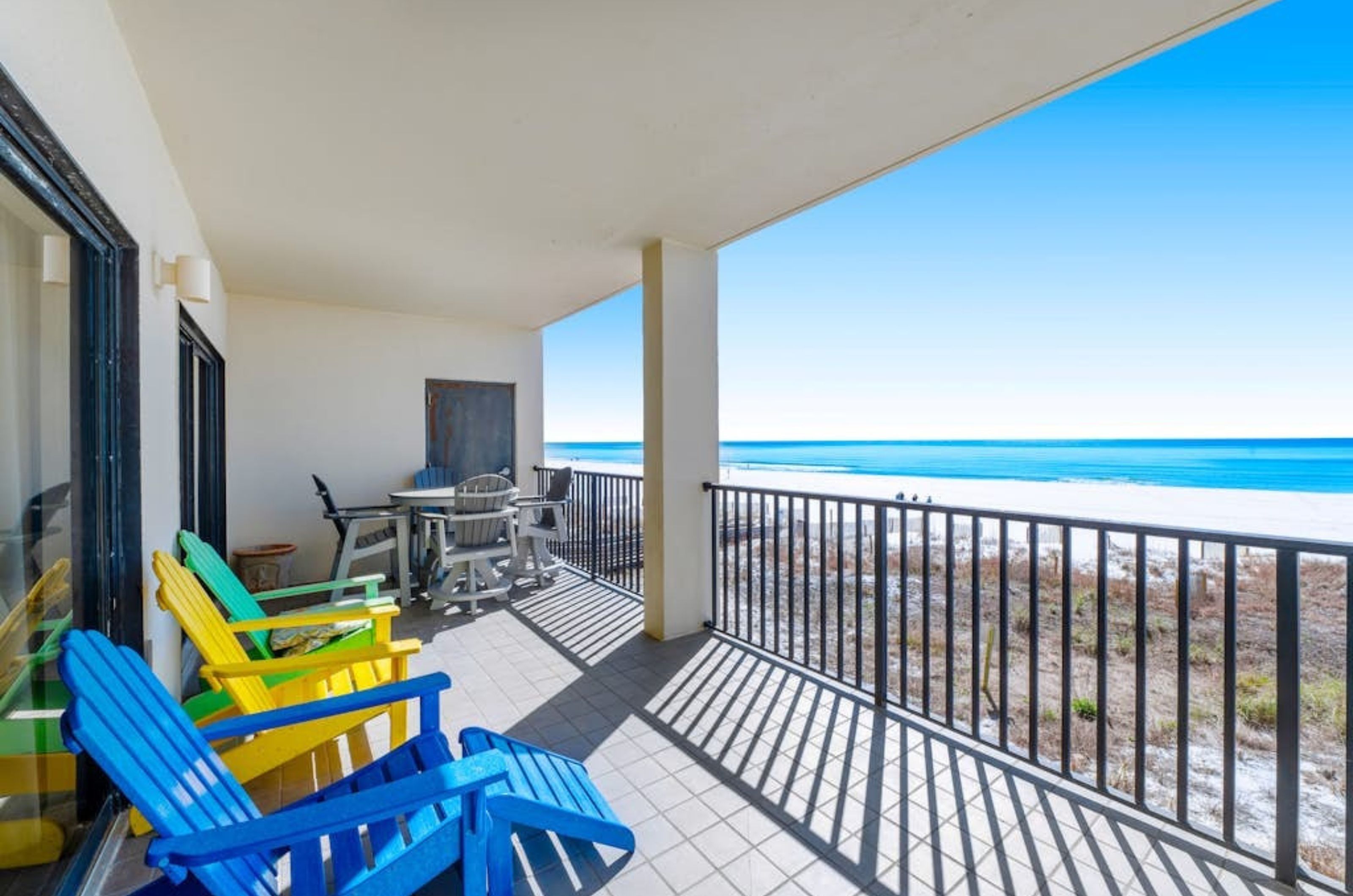 A balcony overlooking the Gulf with lounge chairs at the Palms