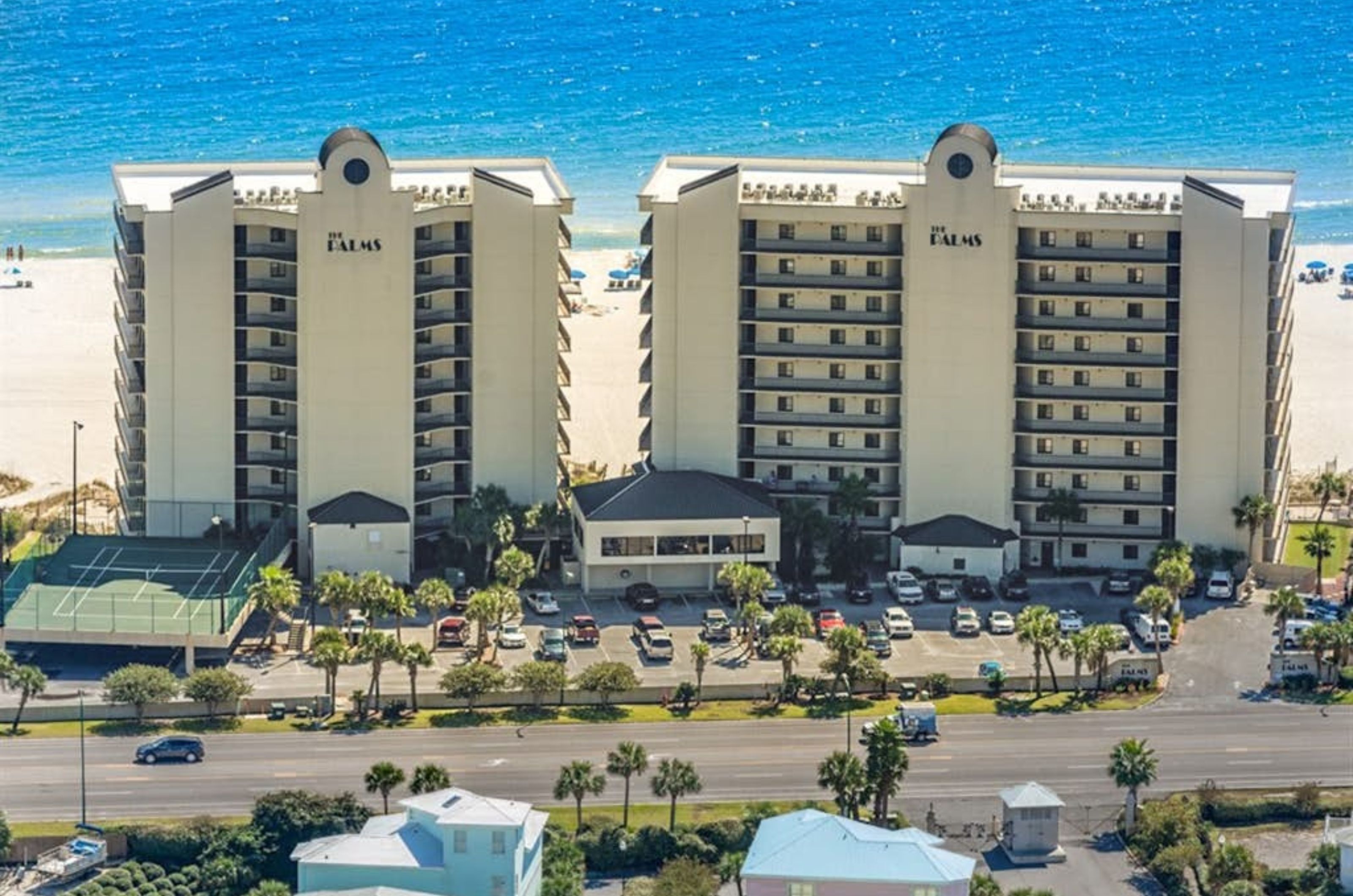 Aerial view from the street side of the Palms with the Gulf in the background