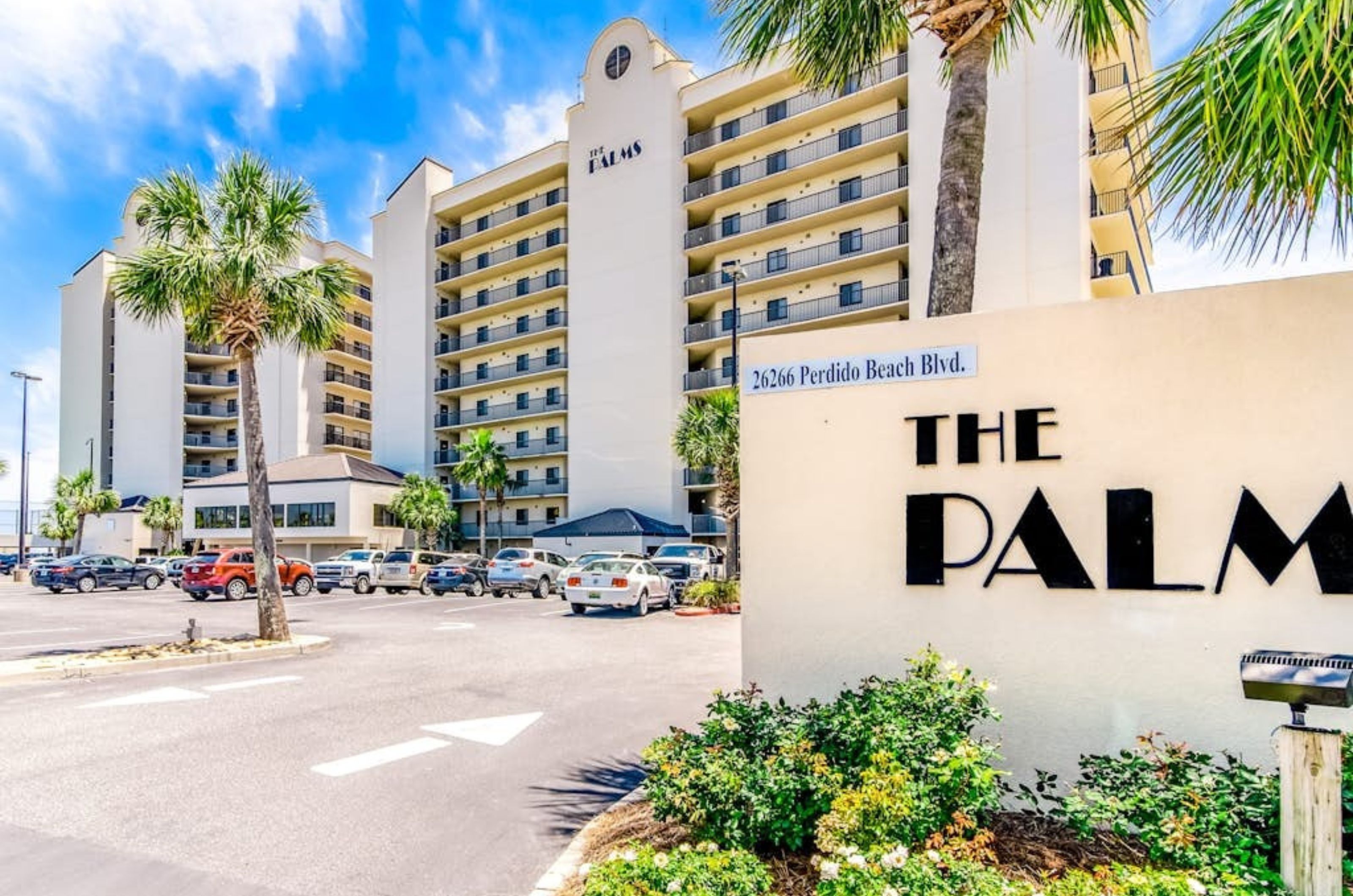 View from the street of the Palms and the entry sign in Orange Beach Alabama 