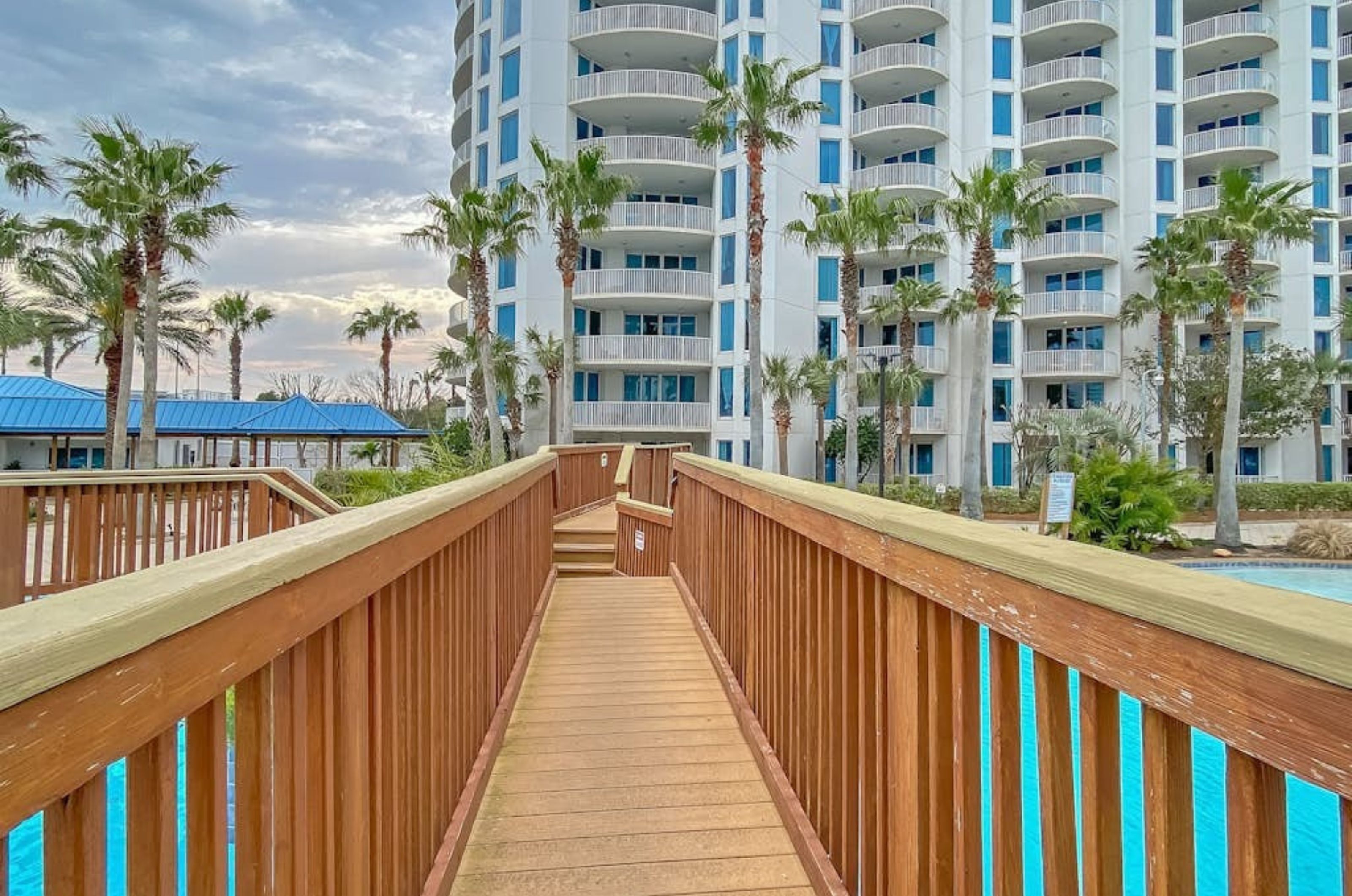 A view on the wooden bridge crossing over the outdoor swimming pool at the Palms of Destin