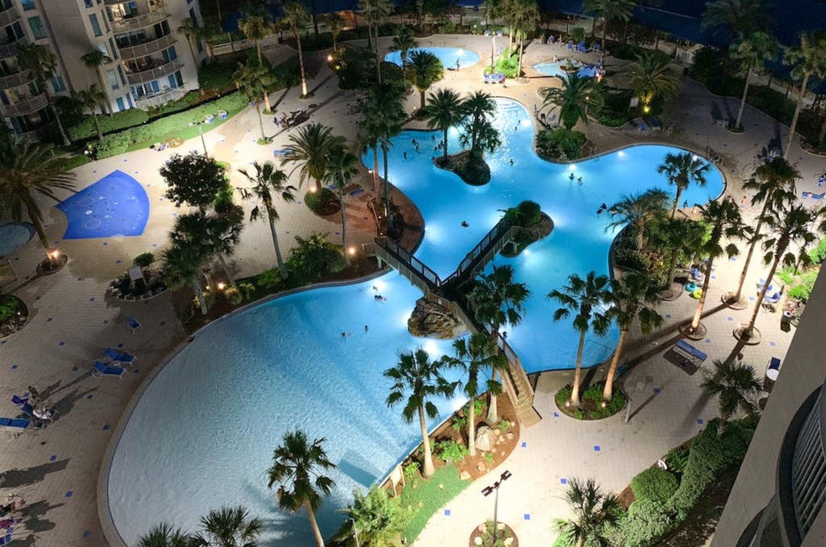 Aerial view of the outdoor swimming pool at night at the Palms of Destin 