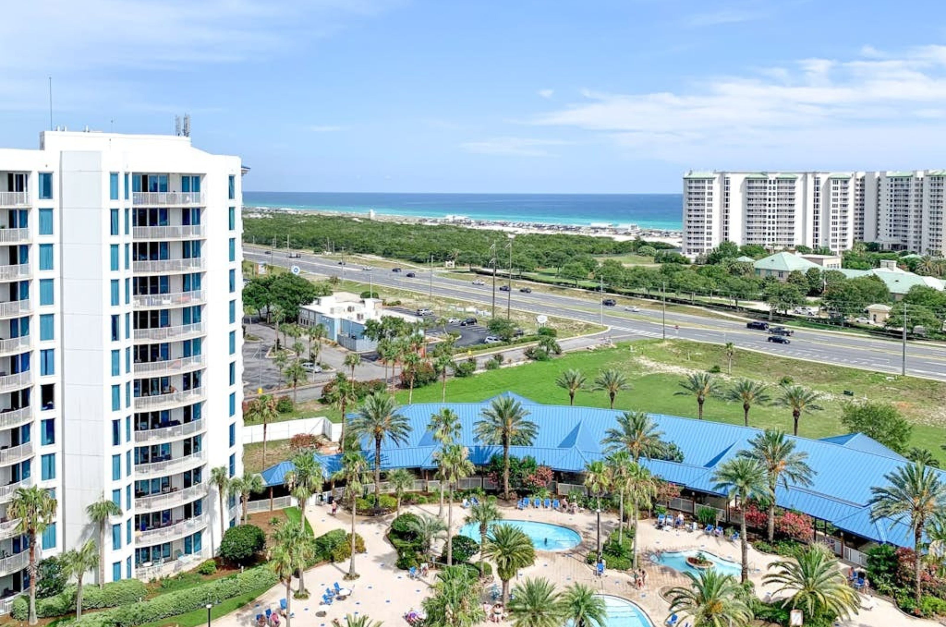 View from a balcony of the pool area and the street that separates the Palms of Destin from the Gulf of Mexico 