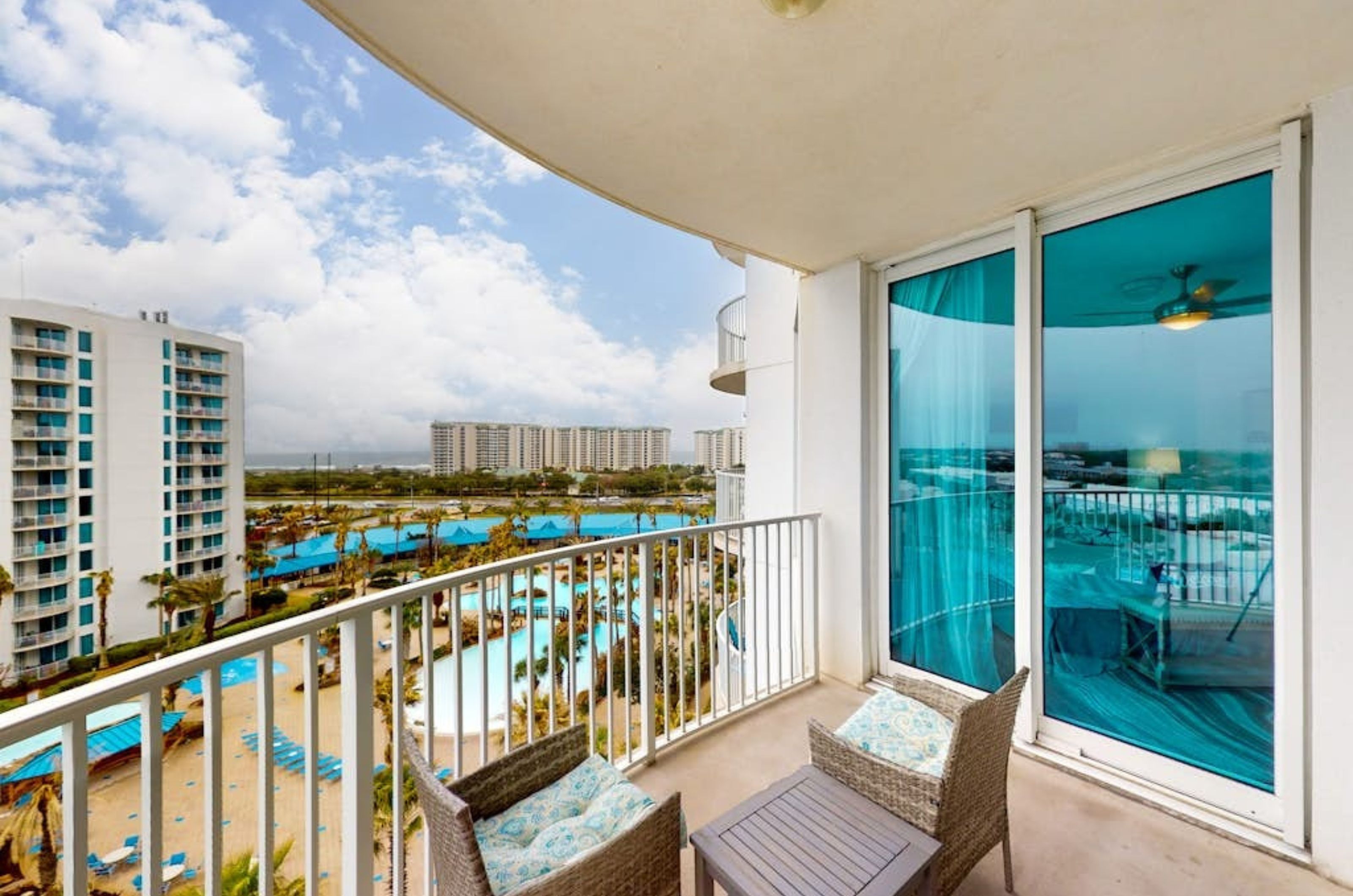 A private balcony with chairs overlooking the the pool area at the Palms of Destin in Destin Florida 