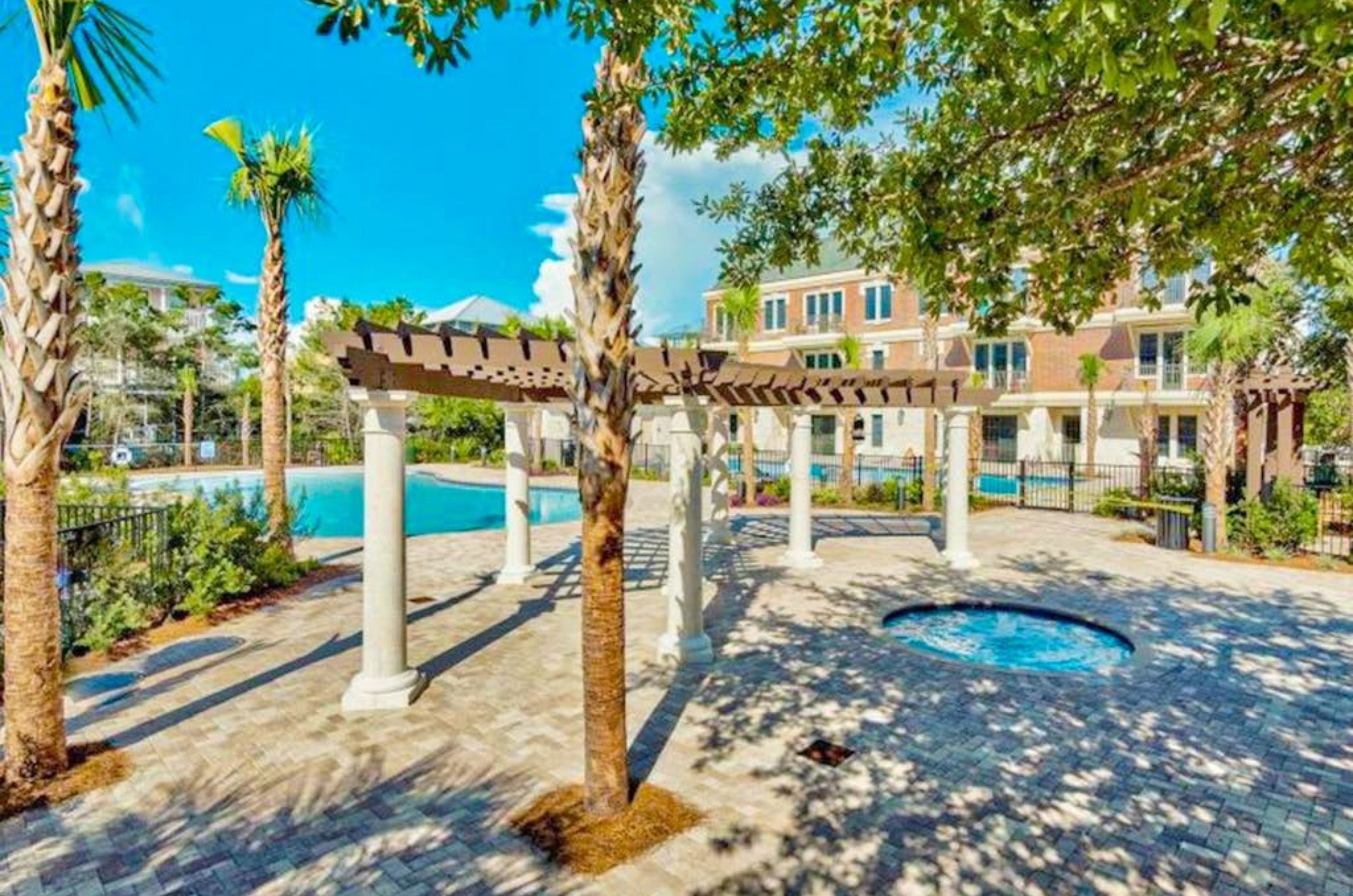 The spacioius pool deck with the outdoor swimming pool and hot tub 