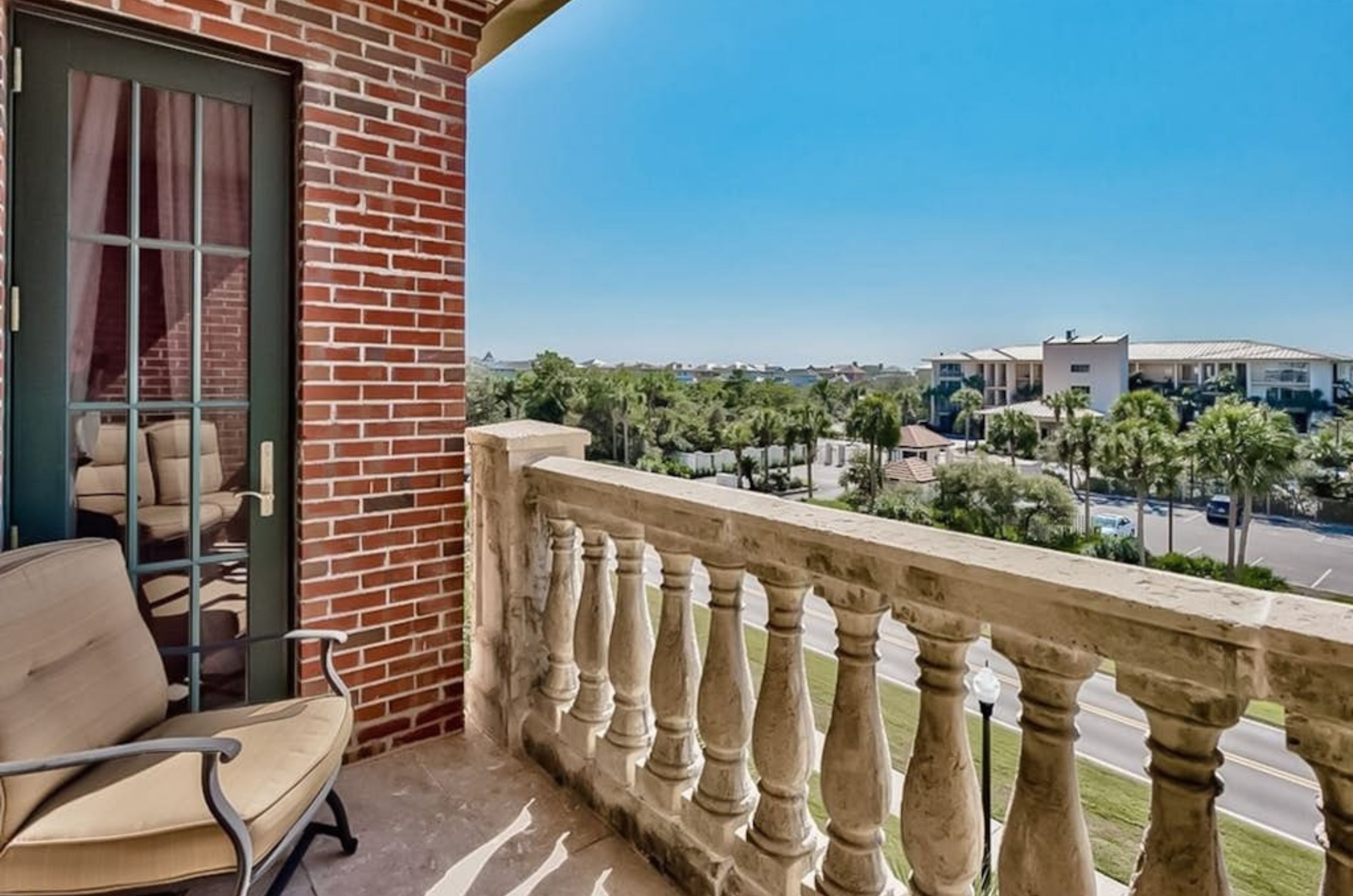 A private balcony overlooking Rosemary Beach with a chair