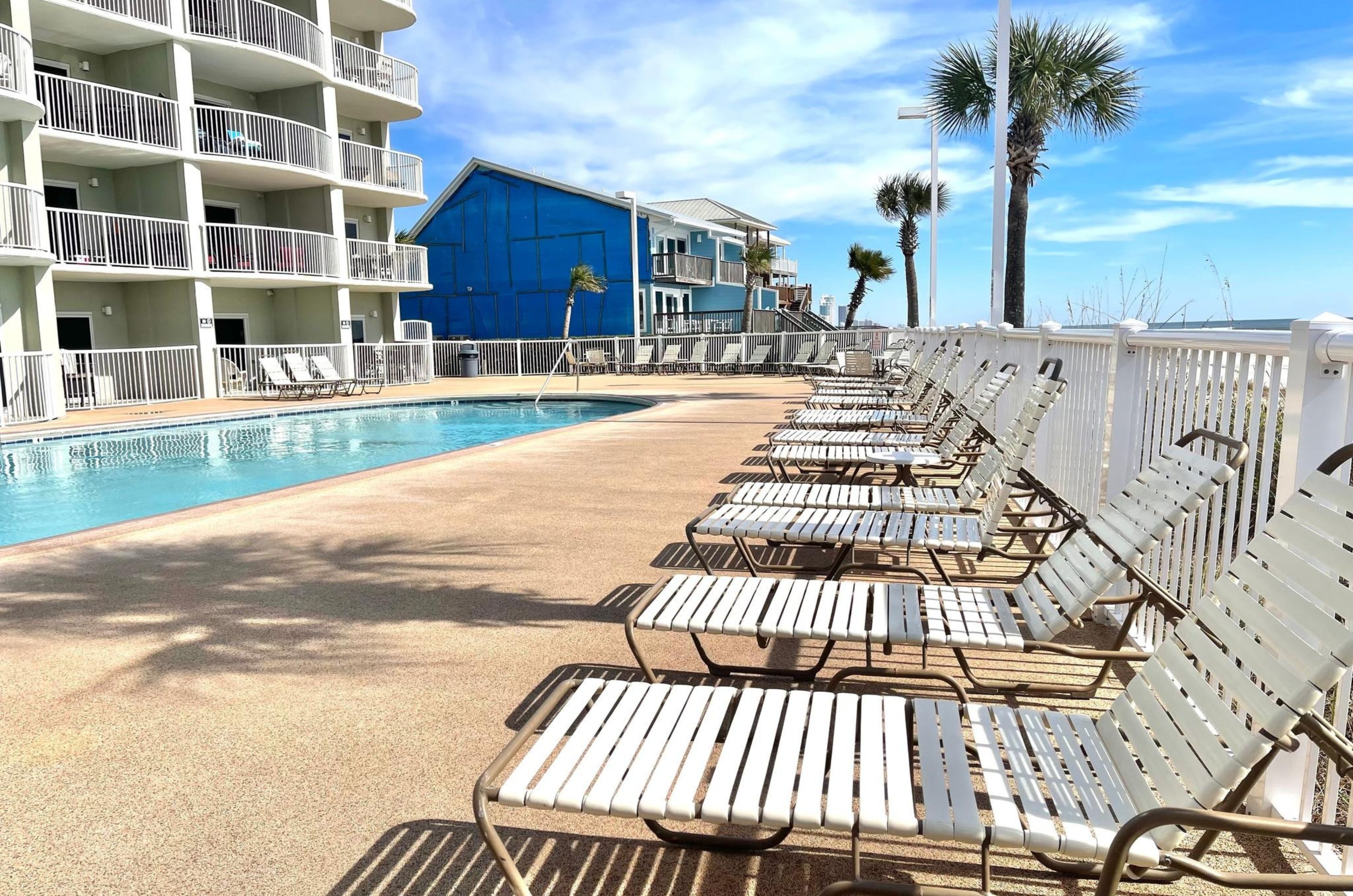 Lounge chairs on the beachside pool deck at Tradewinds