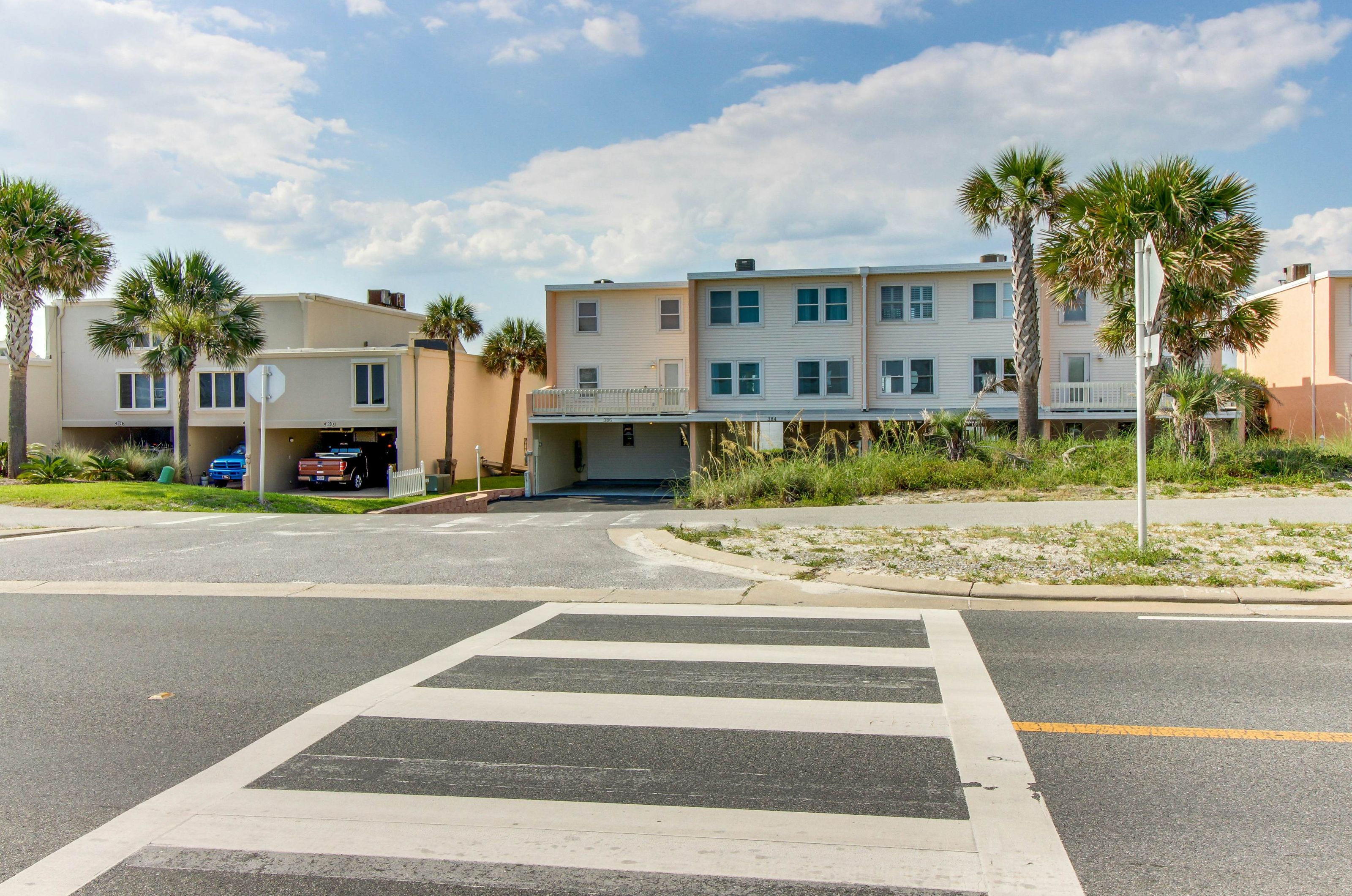 The crosswalk in front of the exterior of Treehouse Townhomes 