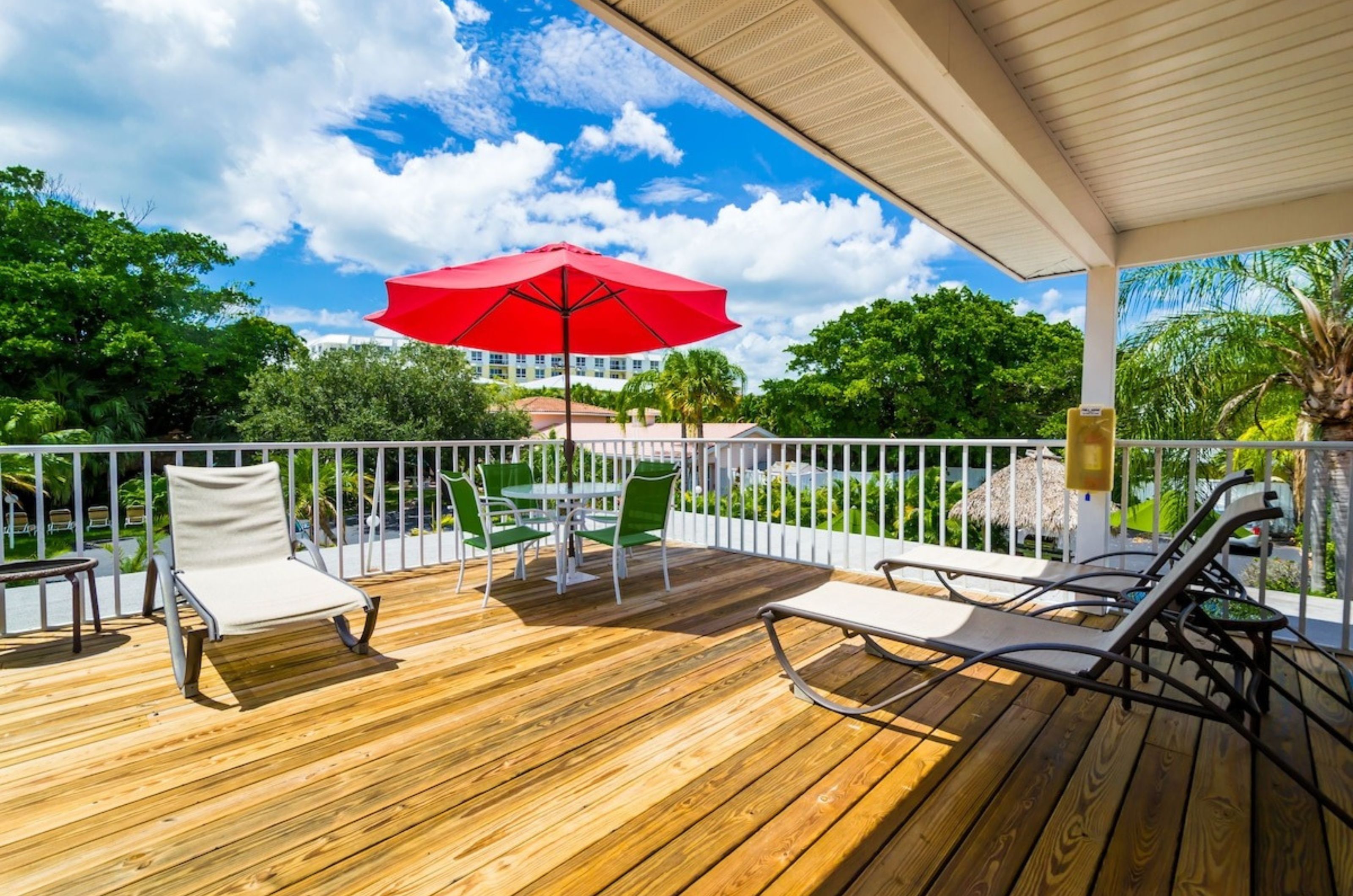An outdoor sundeck with lounge chairs and tables at Tropical Beach Resorts in Siesta Key Florida 