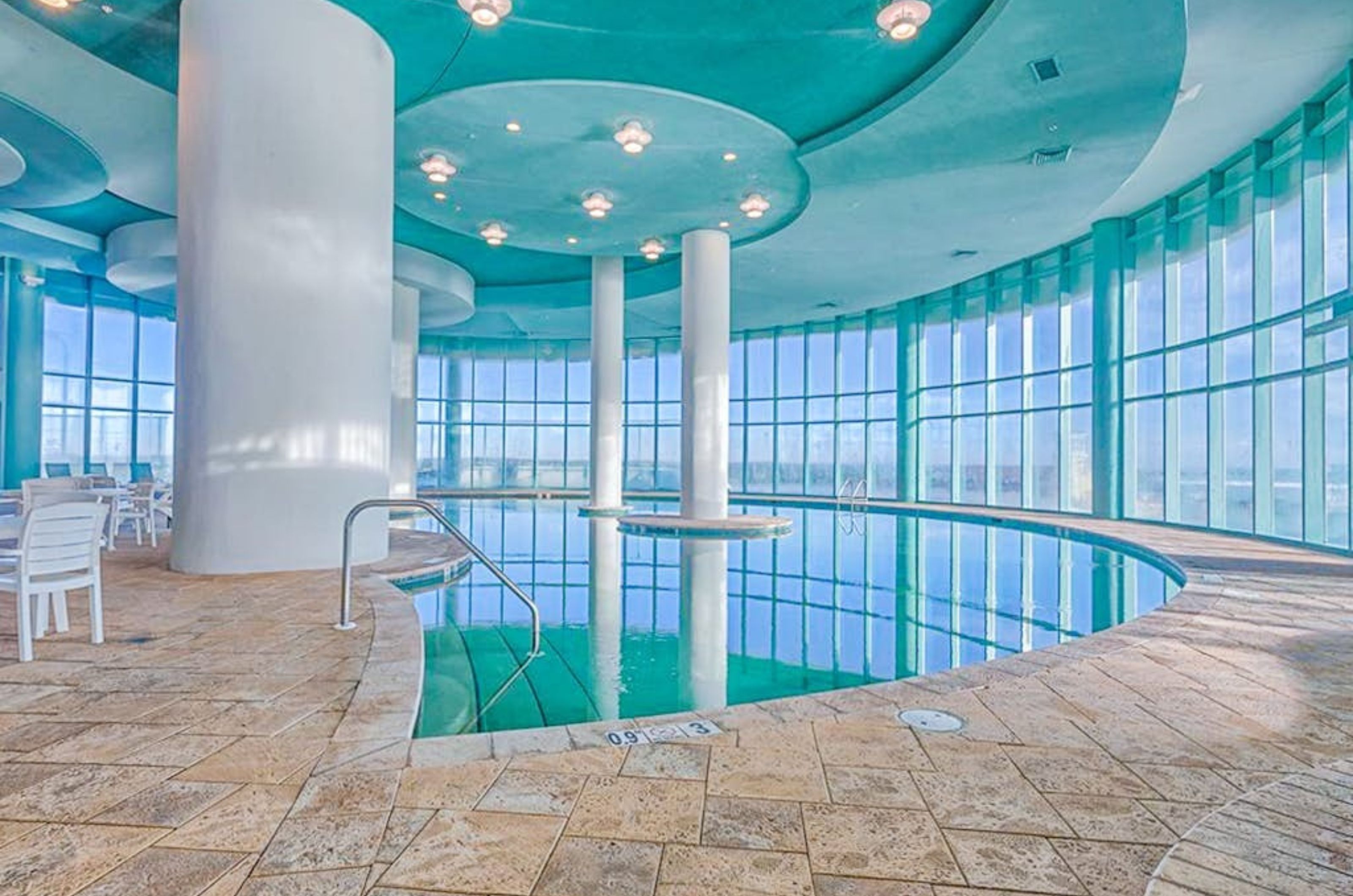 The indoor swimming pool with floor to ceiling windows overlooking the Gulf of Mexico 