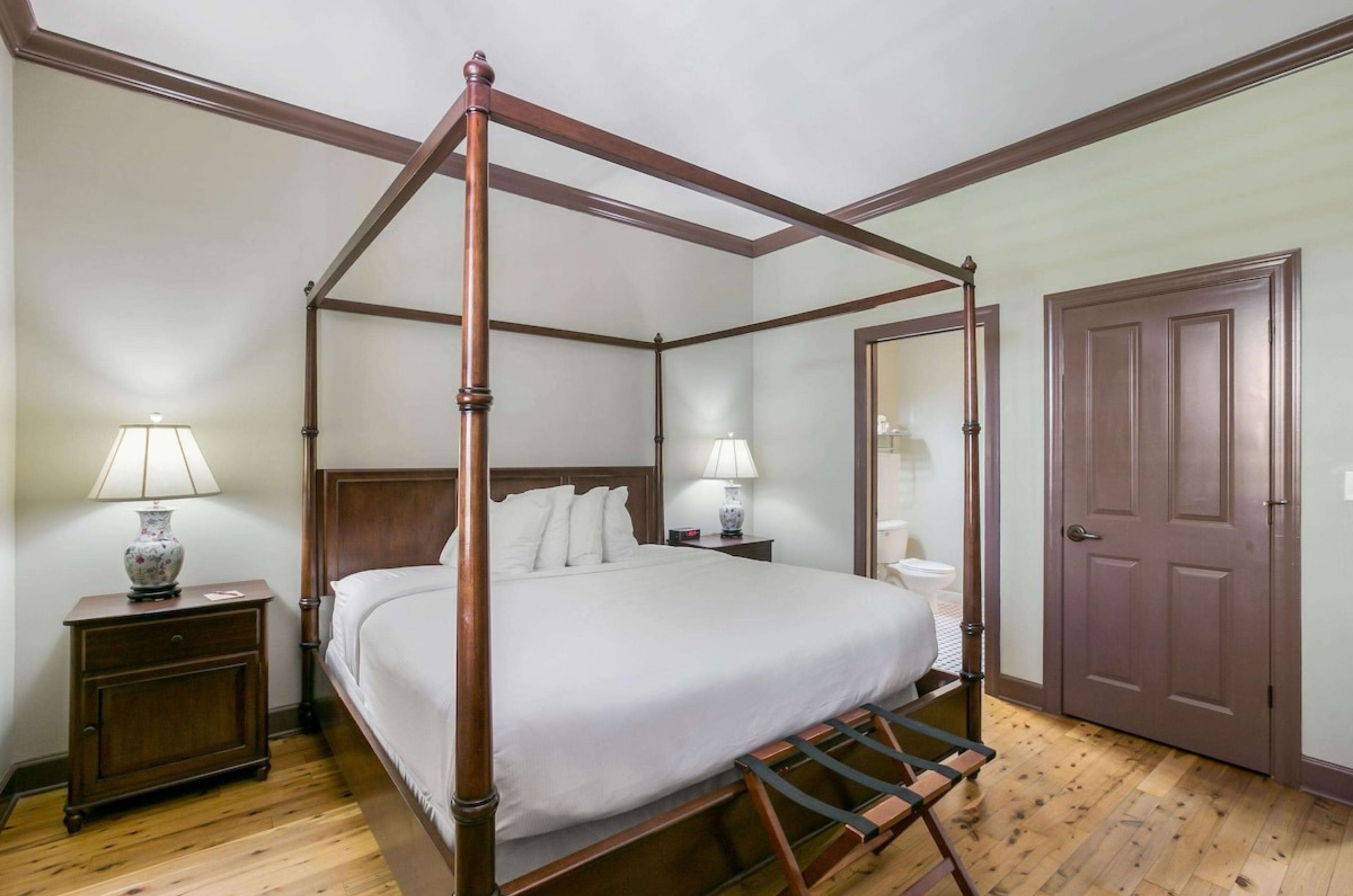 The master bedroom with a four-poster bed at Water Street Hotel & Marina in Apalachicola Florida 