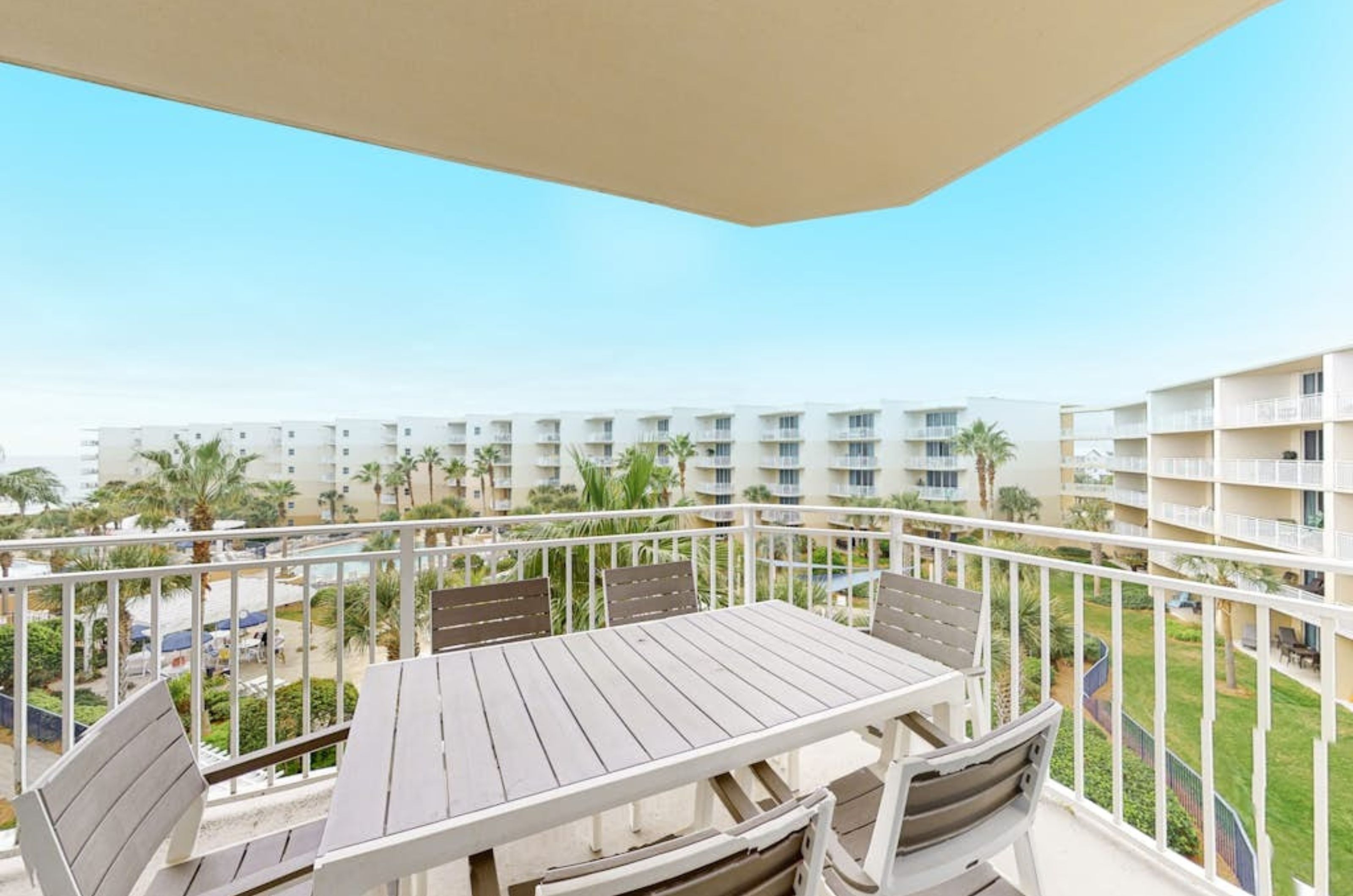 A private balcony with a dining table and chairs at Waterscape in Fort Walton Beach Florida 