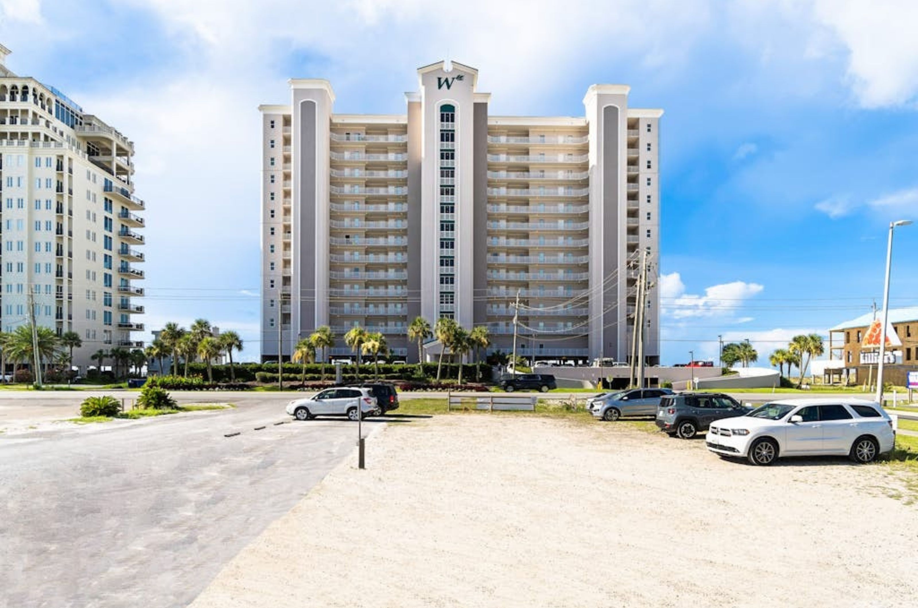 View from the street of Perdido Key with complimentary parking spaces out front 